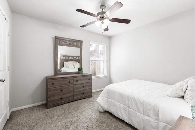 bedroom featuring ceiling fan, baseboards, and light colored carpet