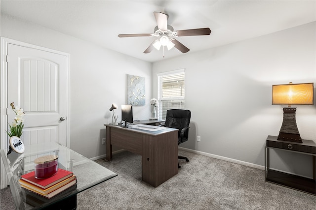 office area with a ceiling fan, light colored carpet, and baseboards