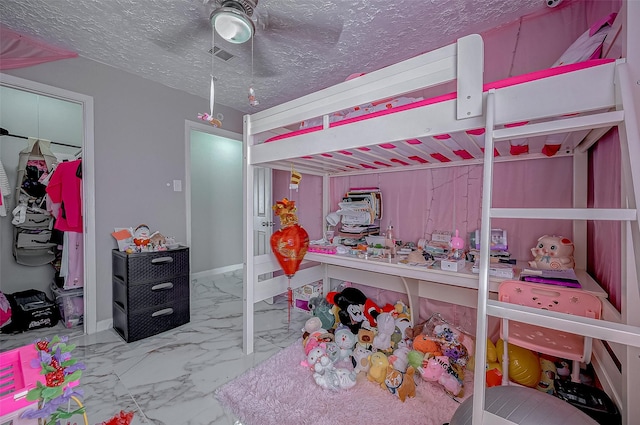 bedroom featuring visible vents, baseboards, a ceiling fan, marble finish floor, and a textured ceiling