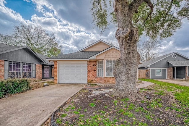 single story home with a garage, driveway, a shingled roof, and brick siding