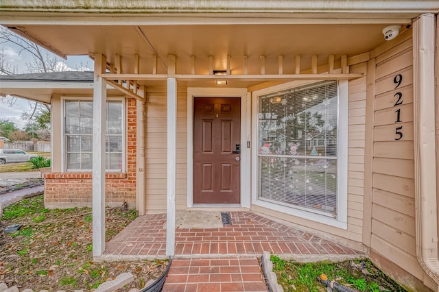 property entrance with brick siding