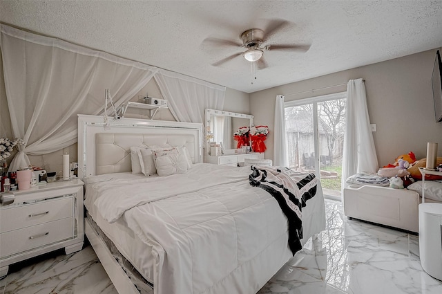 bedroom featuring marble finish floor, access to outside, ceiling fan, and a textured ceiling