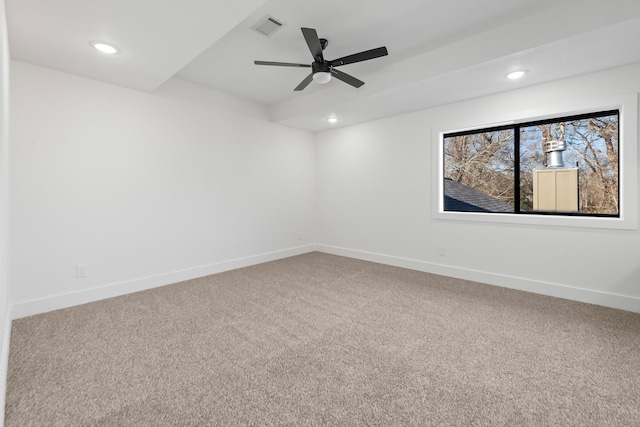 carpeted spare room featuring ceiling fan