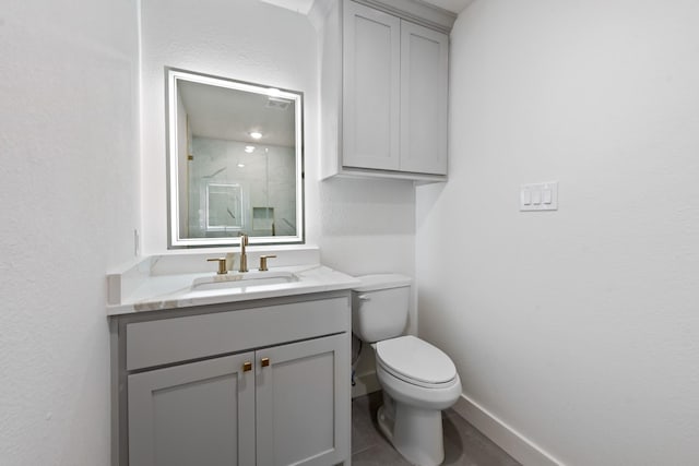 bathroom with vanity, walk in shower, and toilet