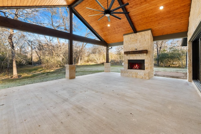 view of patio / terrace with ceiling fan and an outdoor stone fireplace