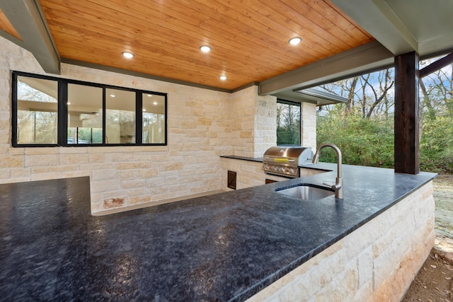 kitchen featuring sink, beam ceiling, and wooden ceiling