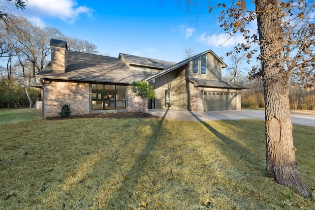 view of front of property featuring a garage and a front lawn