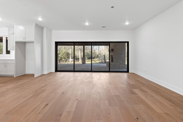 unfurnished living room with light hardwood / wood-style floors