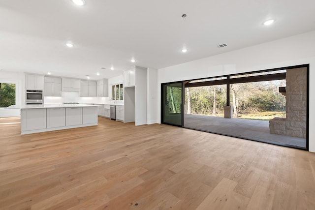 unfurnished living room featuring light hardwood / wood-style floors