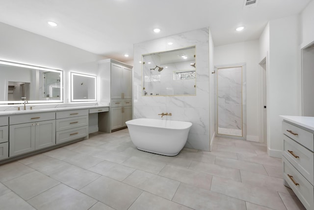 bathroom with vanity and independent shower and bath