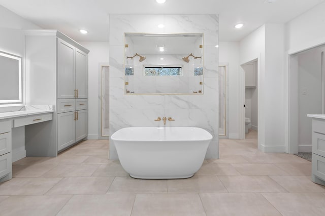 bathroom with vanity, tile patterned floors, and shower with separate bathtub