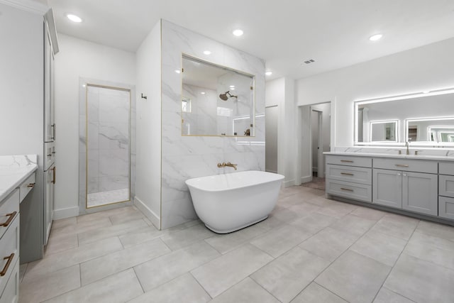 bathroom with vanity and plus walk in shower