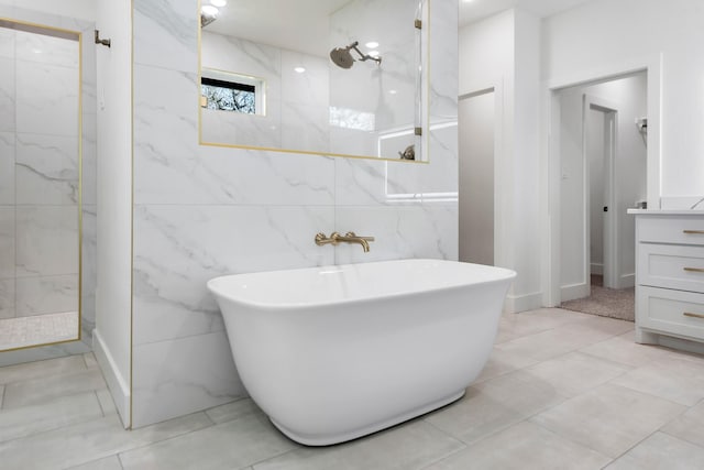 bathroom featuring vanity, tile walls, and separate shower and tub