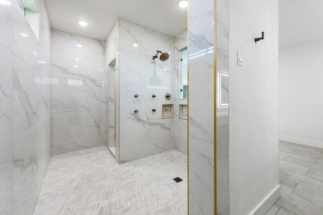 bathroom with tiled shower