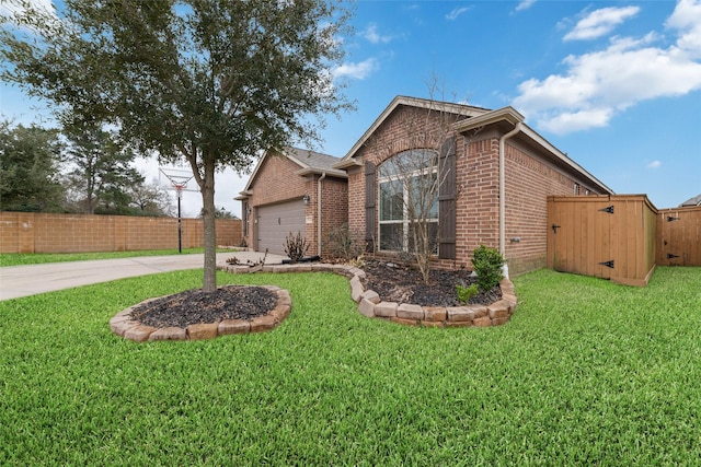 view of home's exterior with driveway, a lawn, an attached garage, fence, and brick siding