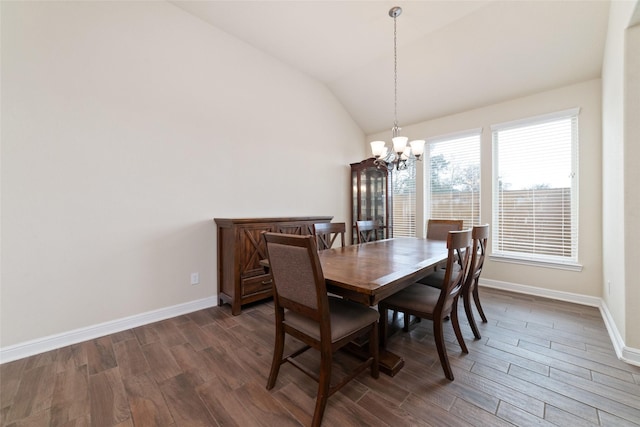 dining space featuring vaulted ceiling, dark hardwood / wood-style floors, and a notable chandelier