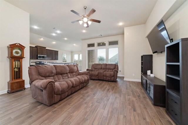 living area featuring recessed lighting, visible vents, ceiling fan, wood finished floors, and baseboards