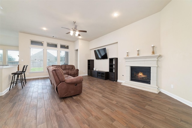 living room featuring wood-type flooring and ceiling fan