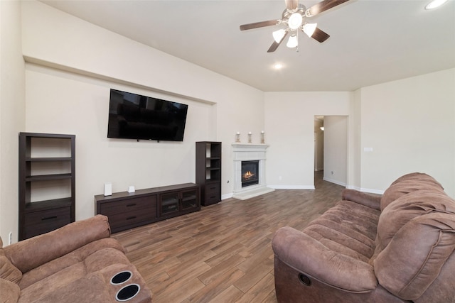 living room featuring hardwood / wood-style floors and ceiling fan