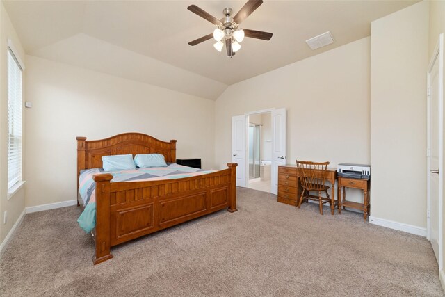 bedroom with light carpet, baseboards, visible vents, connected bathroom, and vaulted ceiling