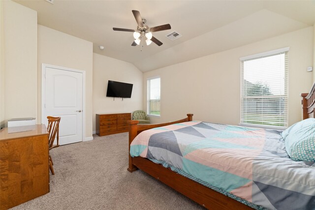 carpeted bedroom with ceiling fan and vaulted ceiling