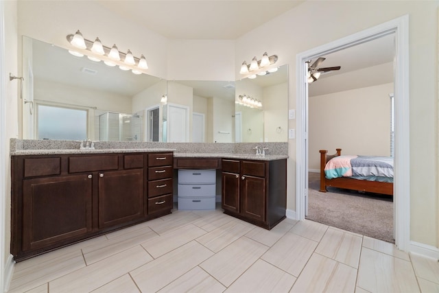 bathroom with ceiling fan, vanity, and a shower with door