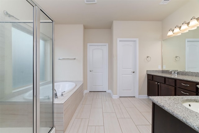 bathroom with vanity and independent shower and bath