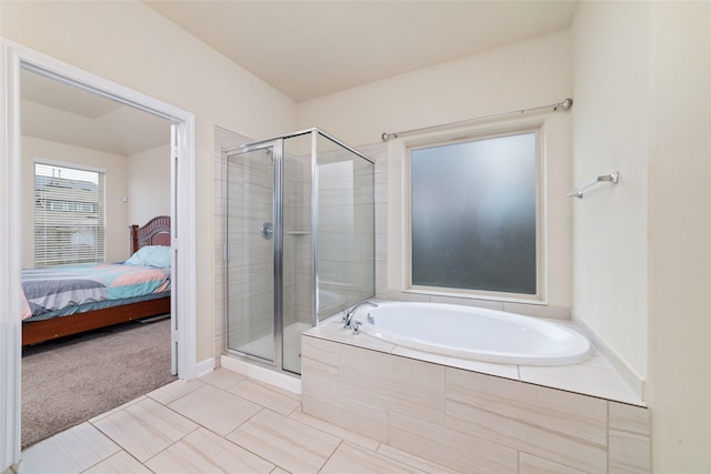 bathroom featuring shower with separate bathtub