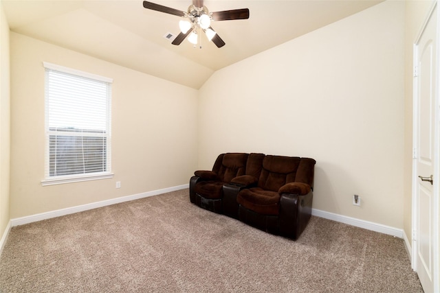 living area with lofted ceiling, light carpet, and ceiling fan