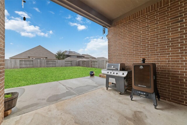 view of patio / terrace with a fenced backyard and a grill