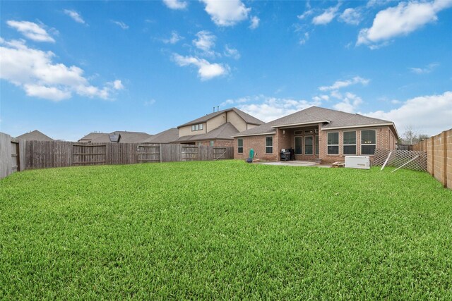 rear view of house featuring a yard and a patio