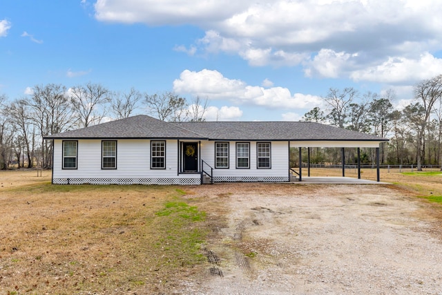 single story home featuring a carport and a front yard