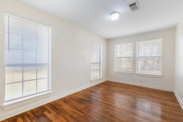 empty room with dark hardwood / wood-style floors