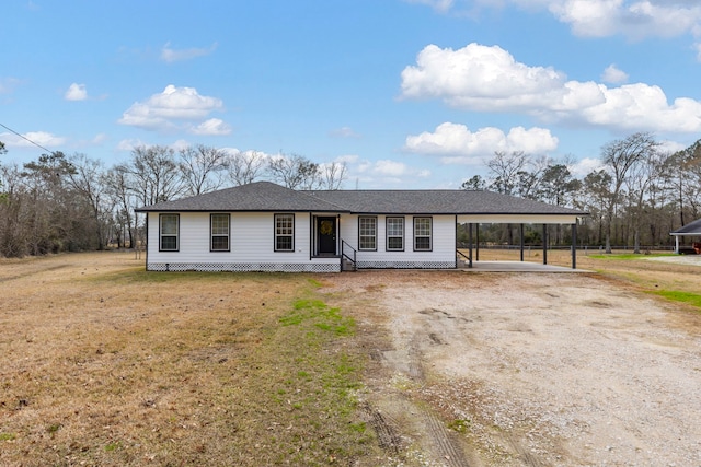 single story home featuring a carport and a front yard