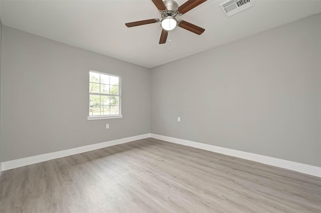 spare room with ceiling fan and light wood-type flooring