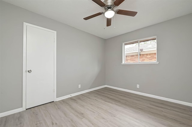 spare room with light hardwood / wood-style floors and ceiling fan