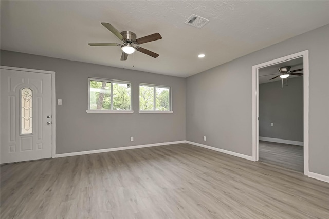 entrance foyer with ceiling fan and light hardwood / wood-style flooring