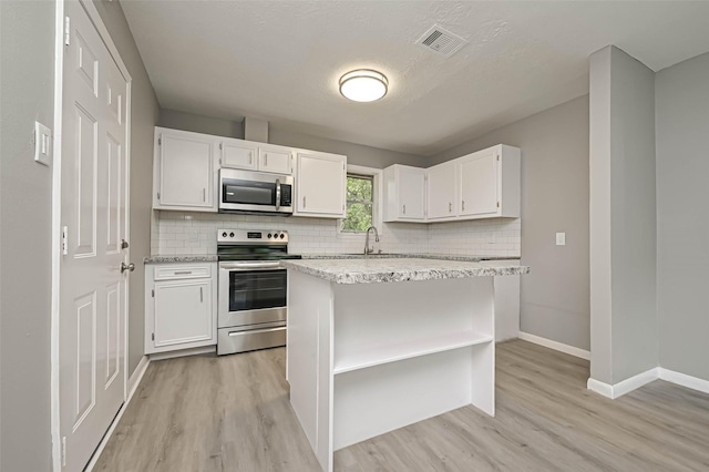 kitchen featuring white cabinetry, appliances with stainless steel finishes, sink, and light wood-type flooring