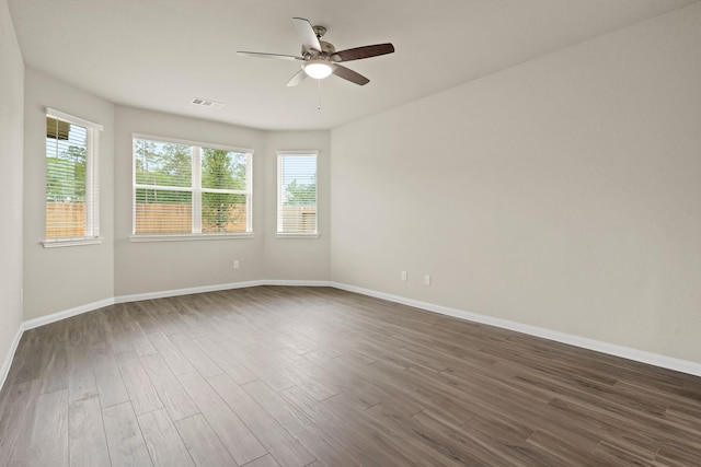 2331 E Chunk Dr, Conroe, TX 77301 - spare room with a healthy amount of sunlight, dark wood-style flooring, a ceiling fan, and visible vents