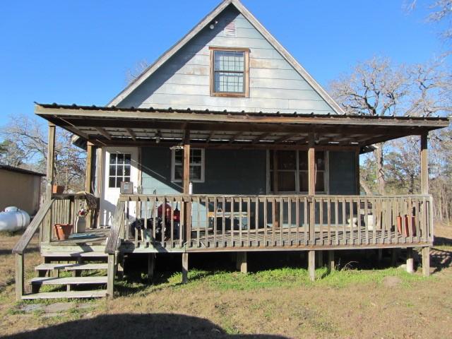 back of house featuring a wooden deck