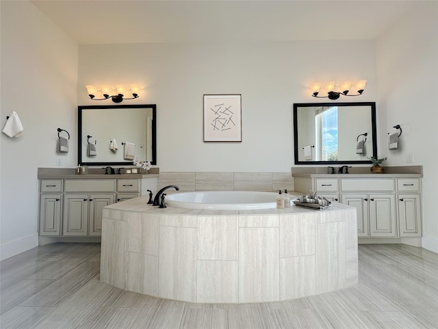 bathroom with vanity and tiled tub