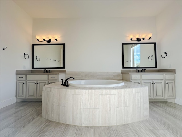 bathroom featuring vanity and tiled bath