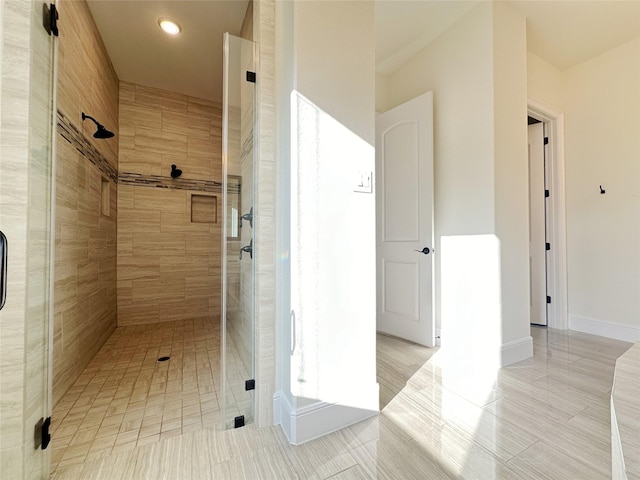 bathroom with a shower with door