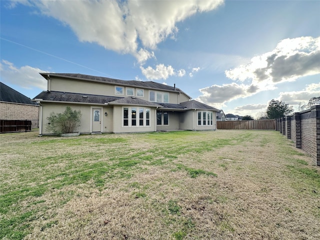 back of house featuring a yard