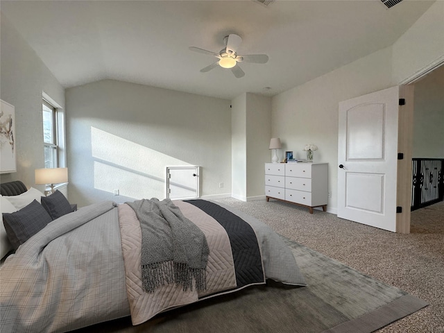 carpeted bedroom with vaulted ceiling and ceiling fan