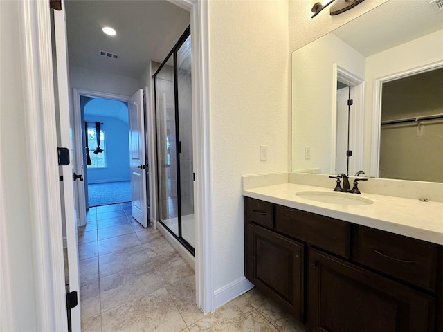 bathroom featuring vanity and an enclosed shower