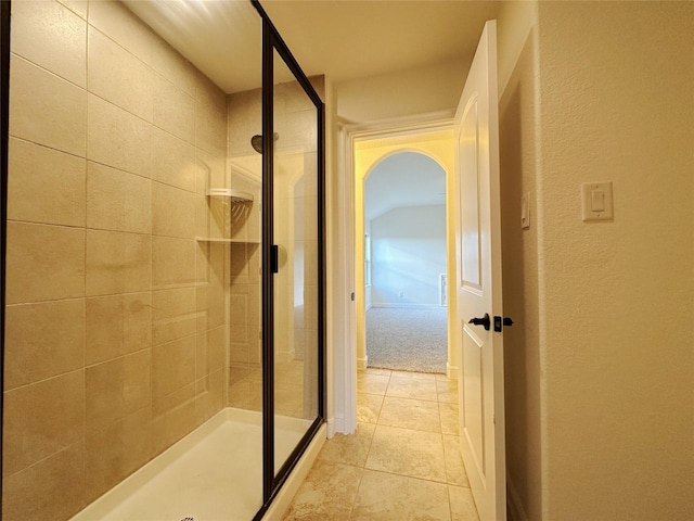 bathroom with tile patterned floors and a shower with shower door