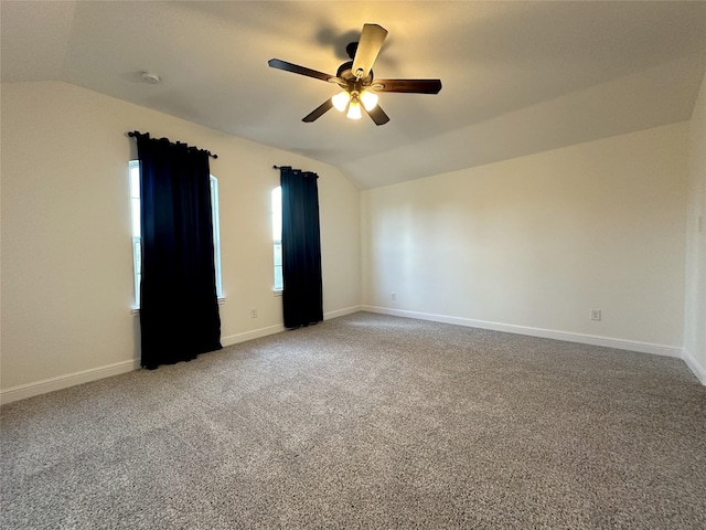 spare room featuring lofted ceiling, carpet floors, and ceiling fan