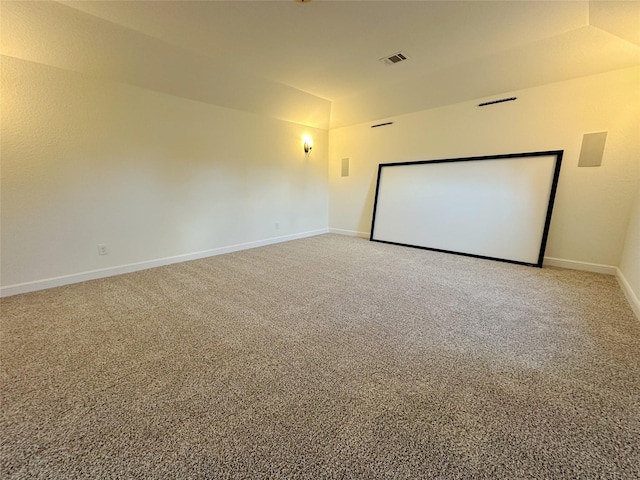 carpeted home theater with lofted ceiling