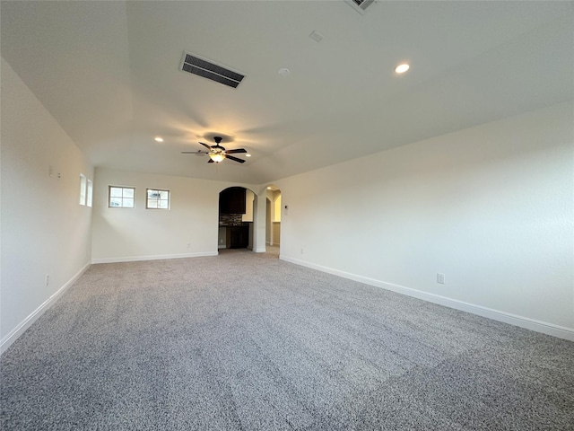 unfurnished living room with ceiling fan and carpet flooring